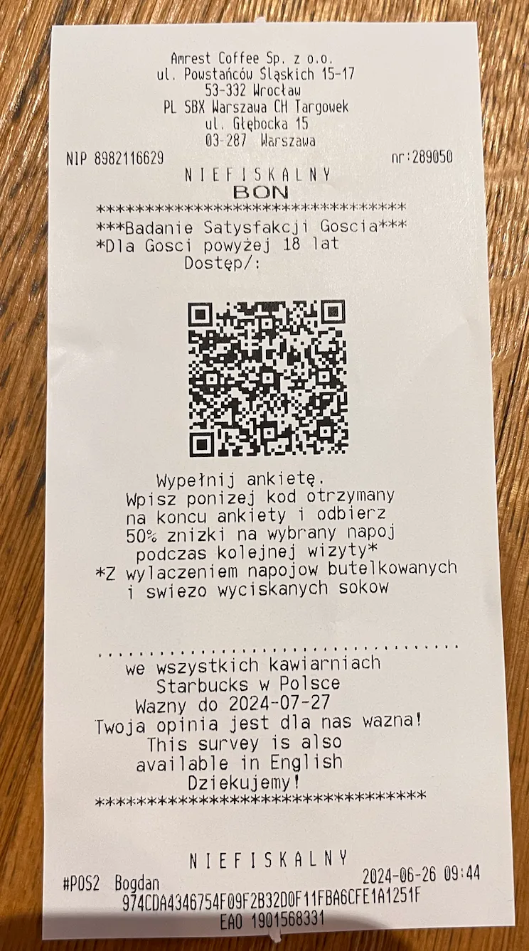A café till receipt printed with a QR code and an invitation to complete a guest satisfaction survey in exchange for a discount on the next visit.